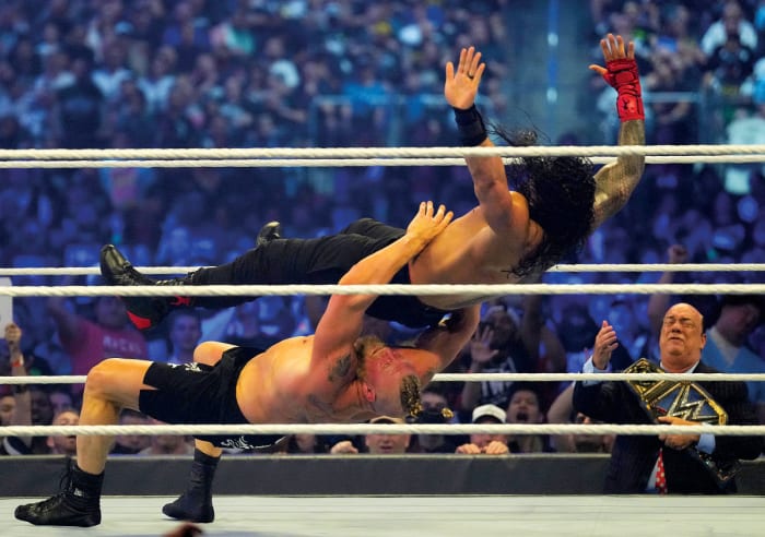 WWE champion Brock Lesnar takes Universal champion Roman Reigns to Suplex City at WrestleMania 38 with one of several belly-to-back suplexes that have become Lesnar's signature moves since introducing it in a squash match against John Cena many years ago.
